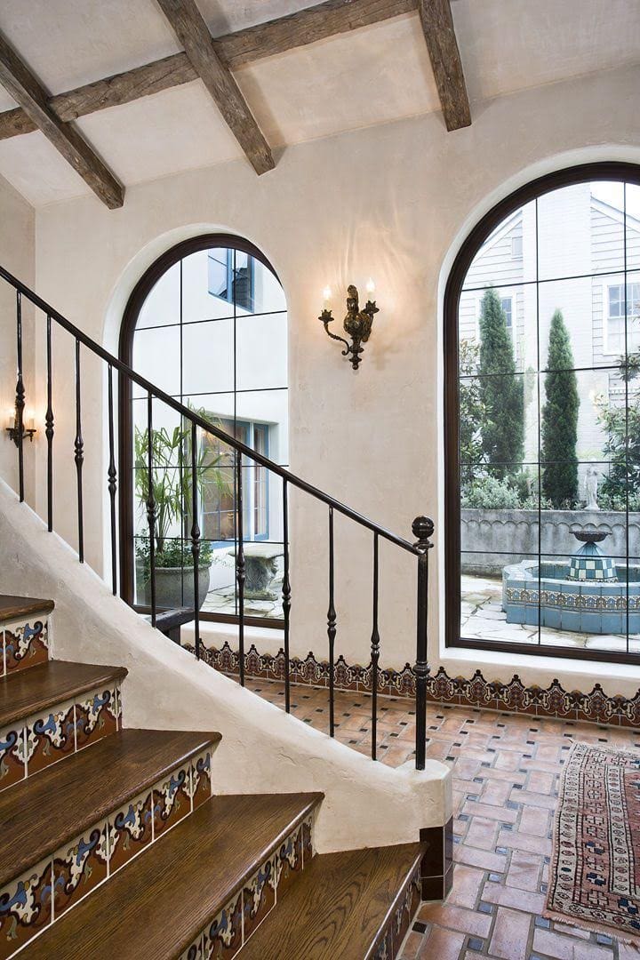 spanish style house with tile floors, wood staircase, wrought iron, plaster