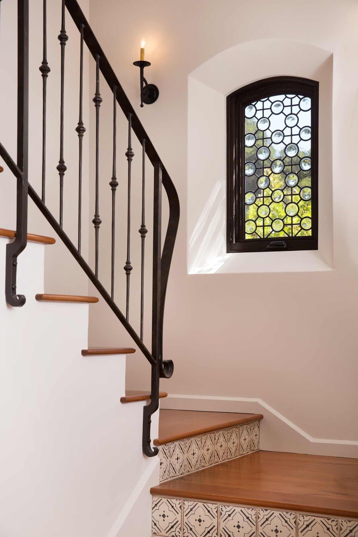 spanish style stairway with wrought iron railing