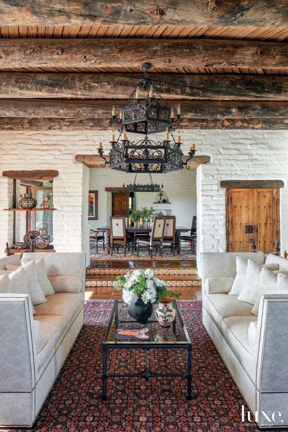 rustic spanish style living room with brick walls