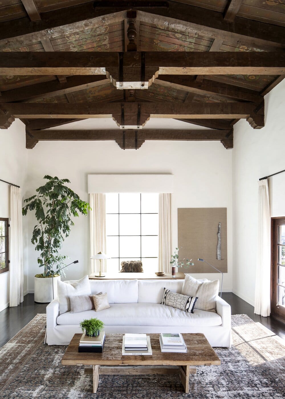 spanish style living room with dark wood beam ceilings