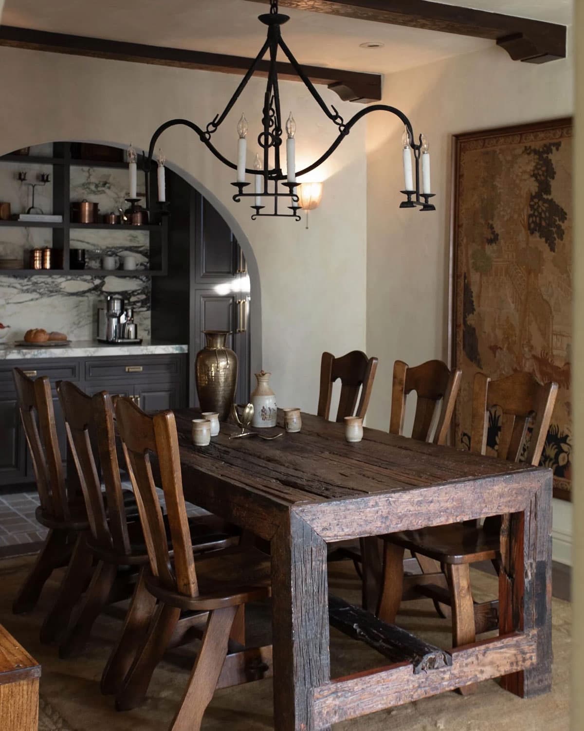 spanish style dining room with rustic wood table