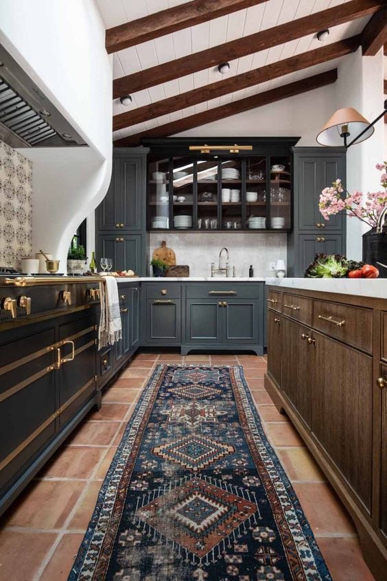 spanish style kitchen with saltillo tile and blue cabinets