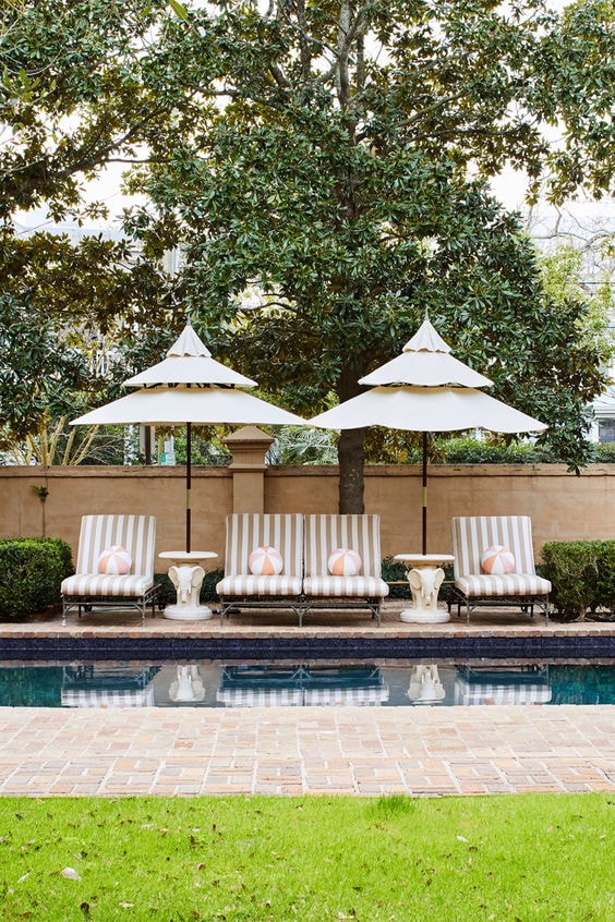 striped cabana chaise lounges by the pool