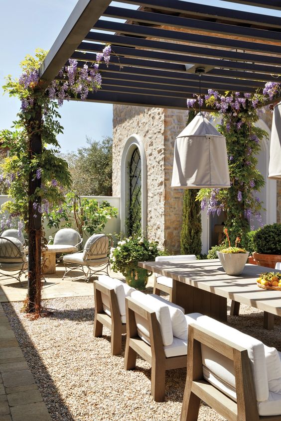 outdoor dining under wood pergola with vines